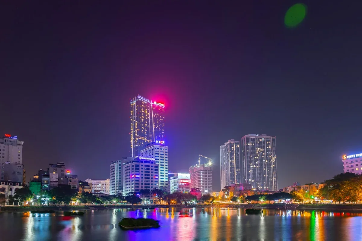 Illuminated Hanoi skyline reflected in the water at night, Vietnam